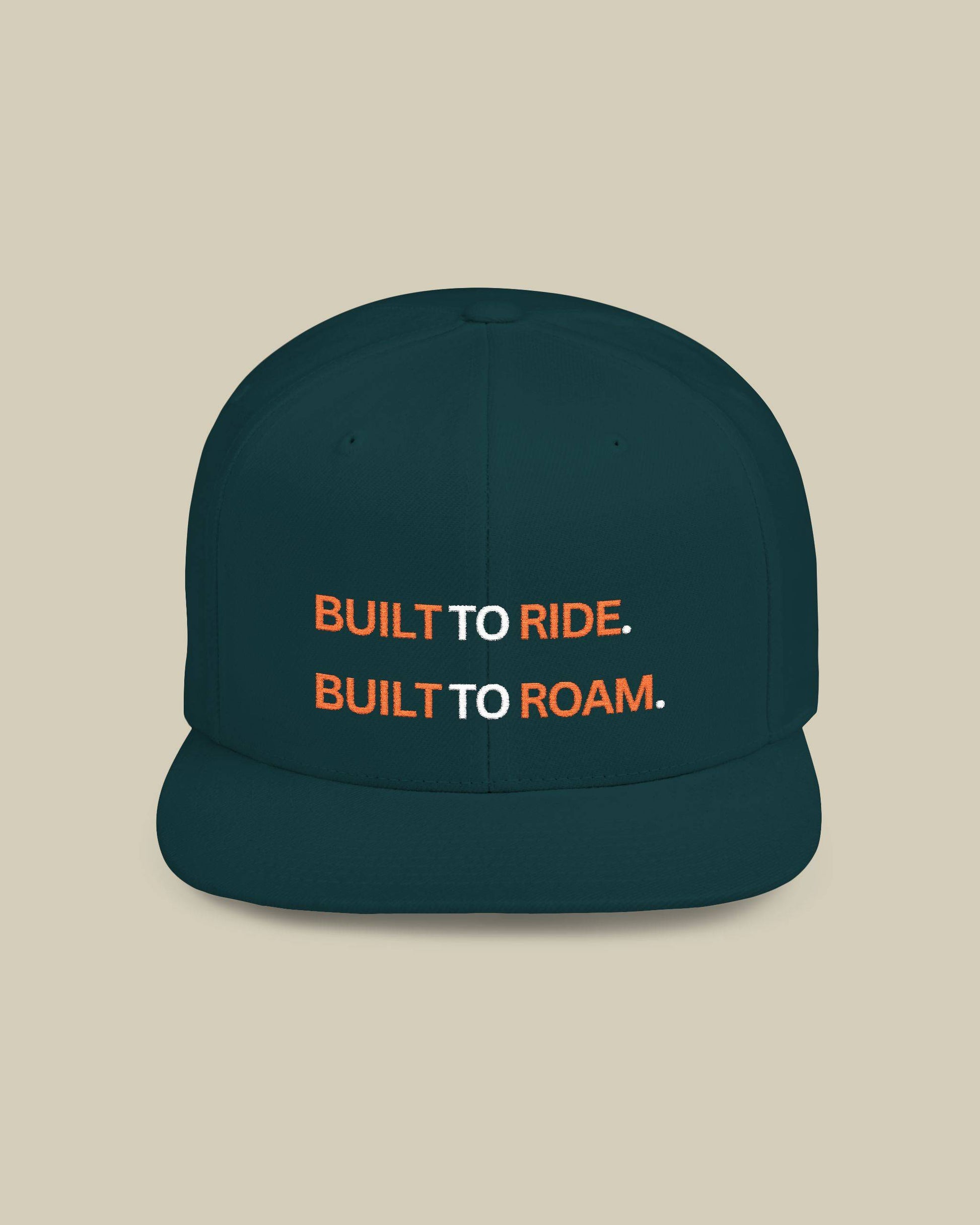 Navy blue cap with 'Built to Ride. Built to Roam.' text on a beige background