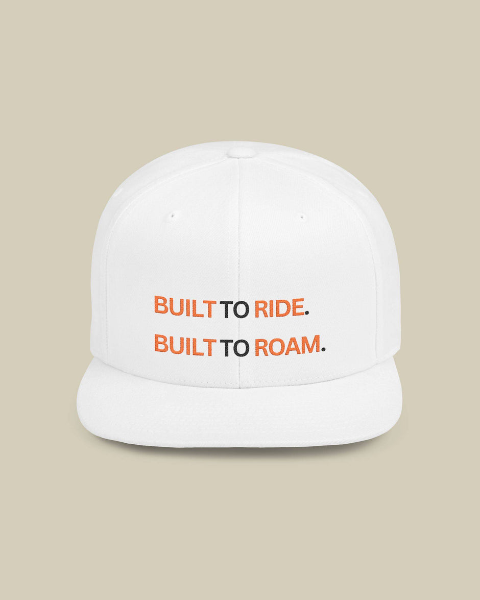 White cap with 'Built to Ride. Built to Roam.' text on a beige background