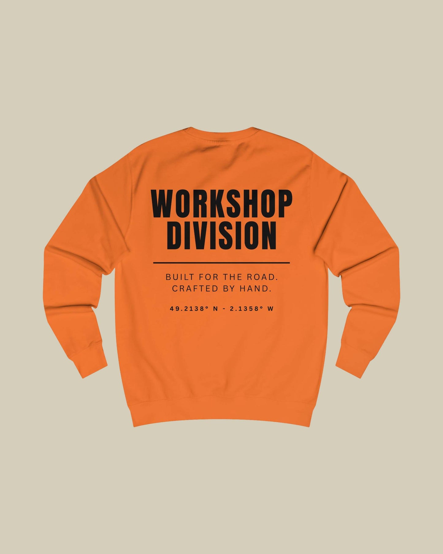 Orange sweatshirt with 'Workshop Division' text on a beige background