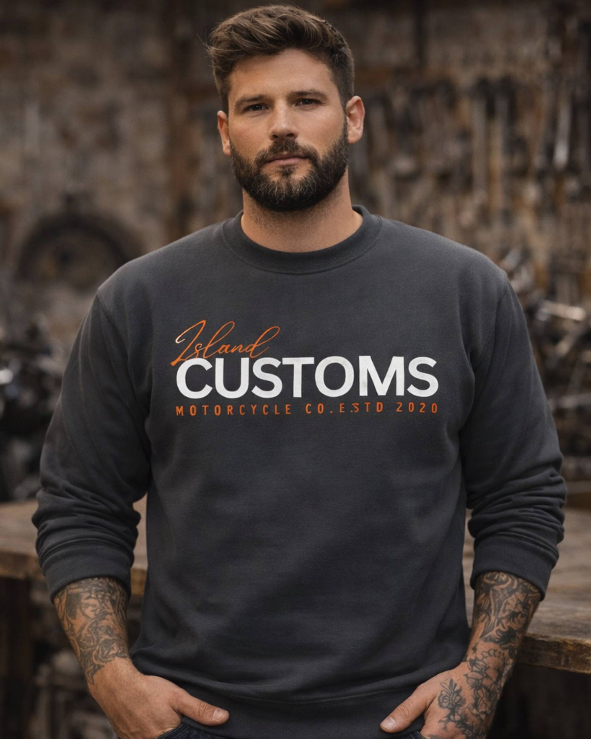Man wearing a black sweatshirt with 'Island Customs Motorcycle Co.' text in a workshop setting