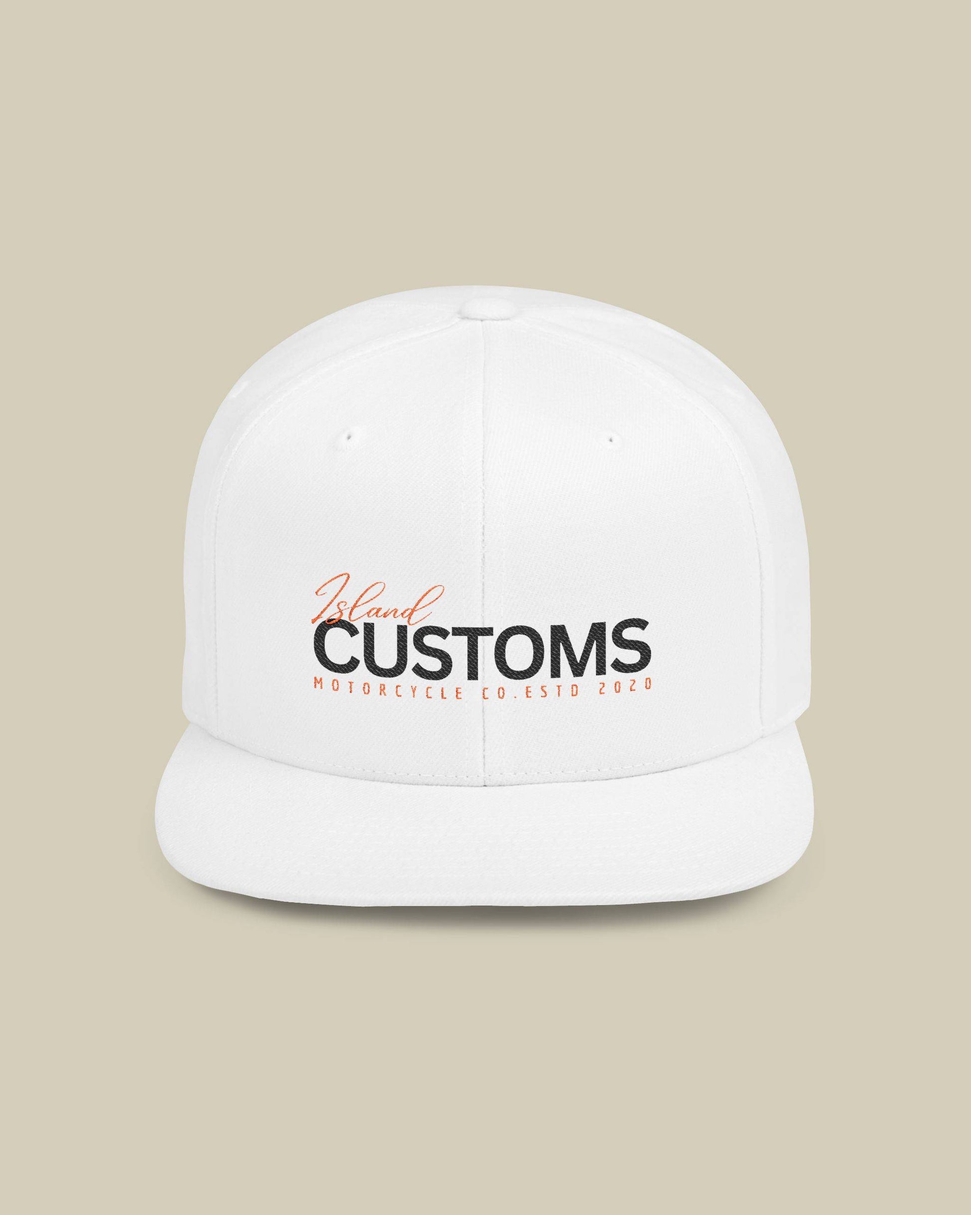 White cap with 'Customs' logo on a beige background