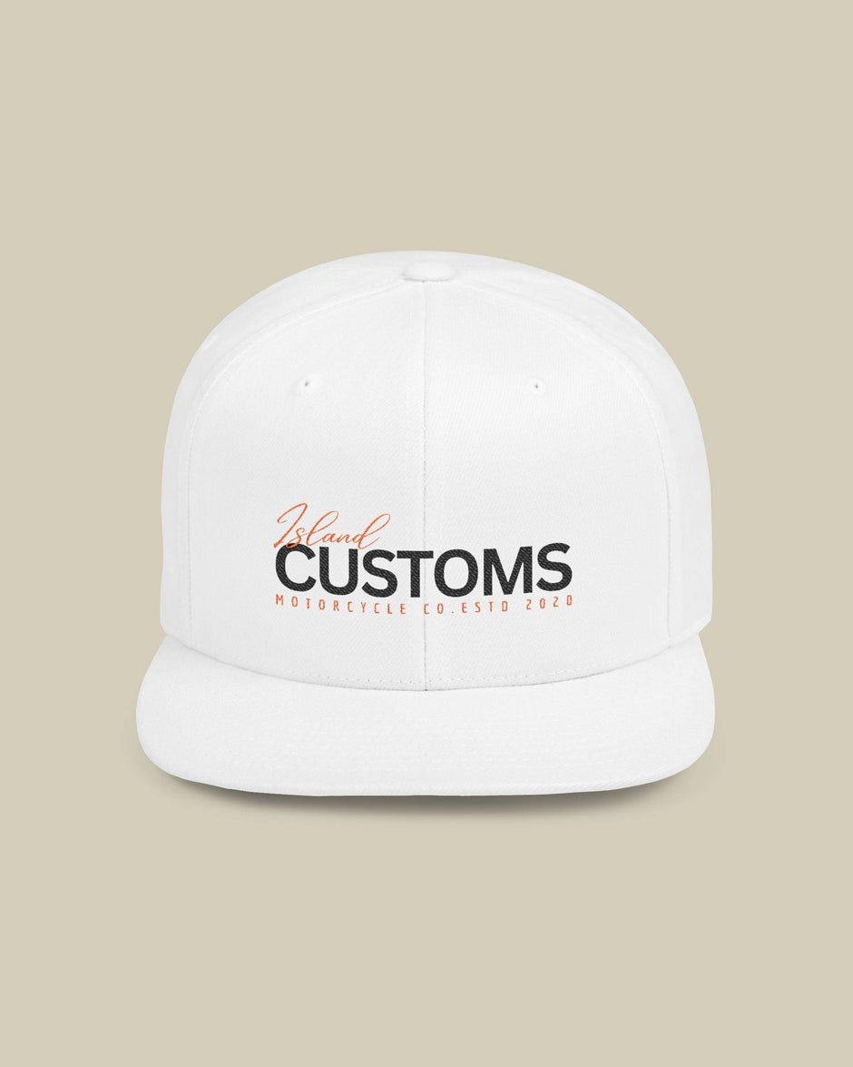 White cap with 'Customs' logo on a beige background