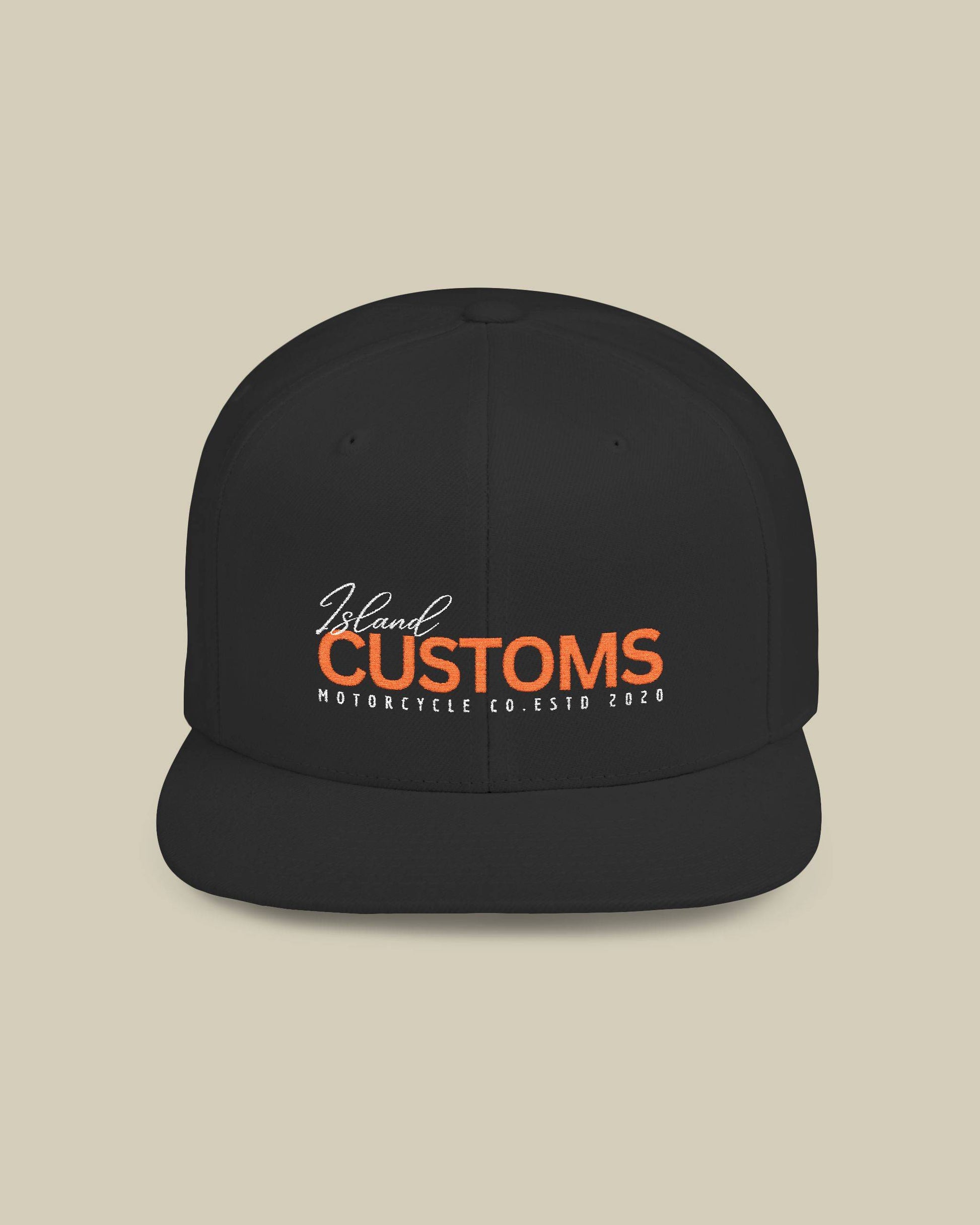 Black cap with 'Island Customs' logo on a beige background
