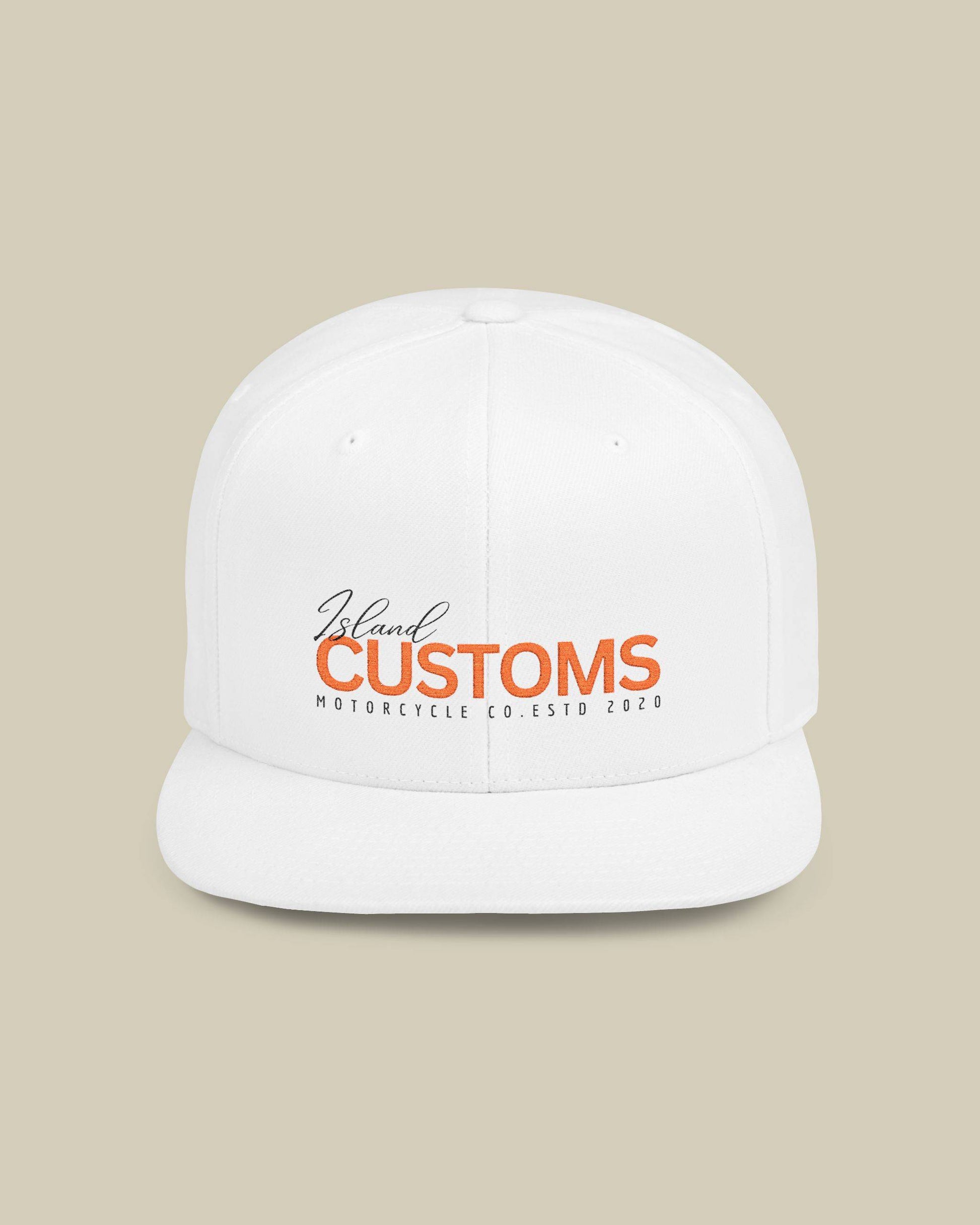 White cap with 'Island Customs' logo on a beige background