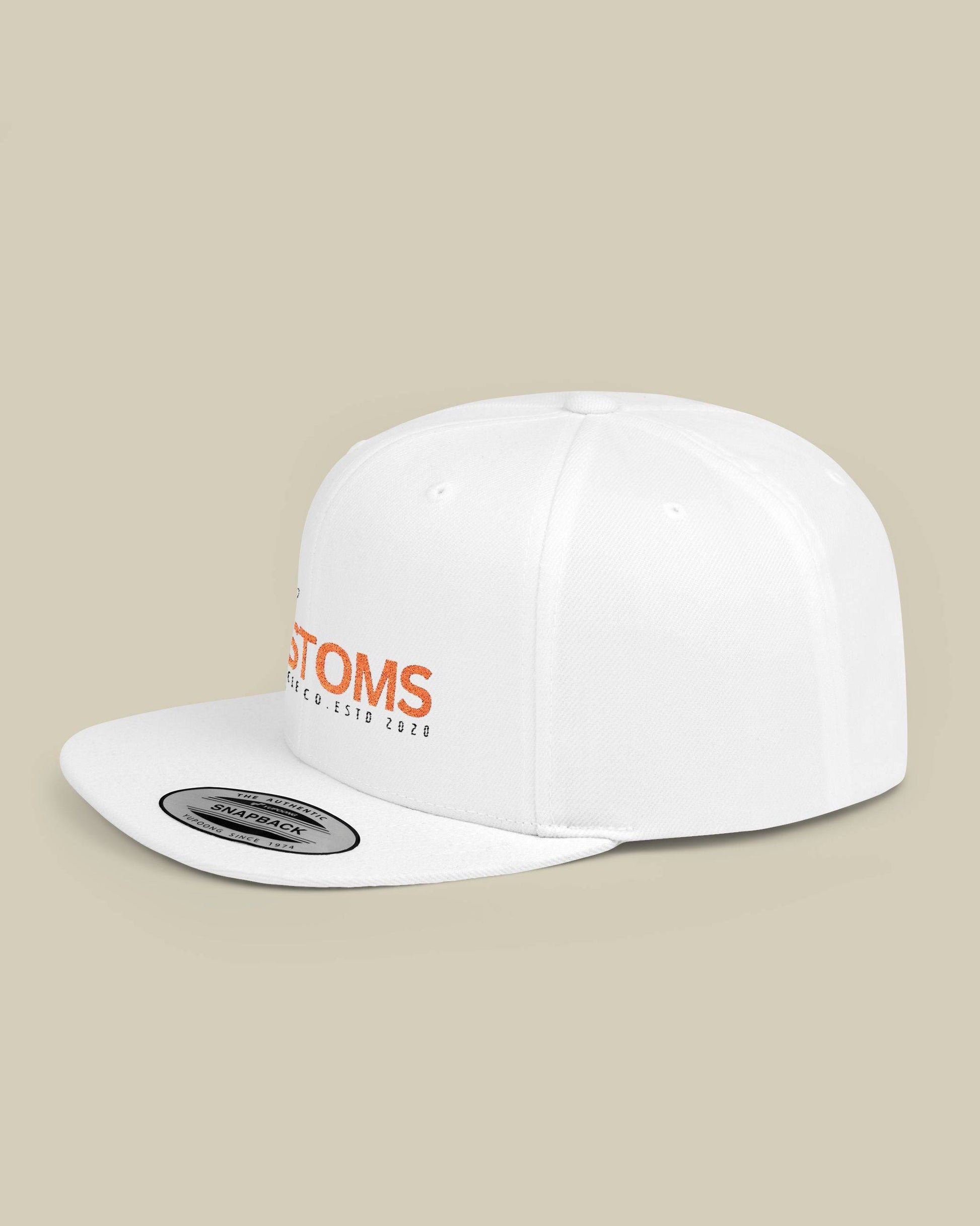 White cap with orange text on a beige background