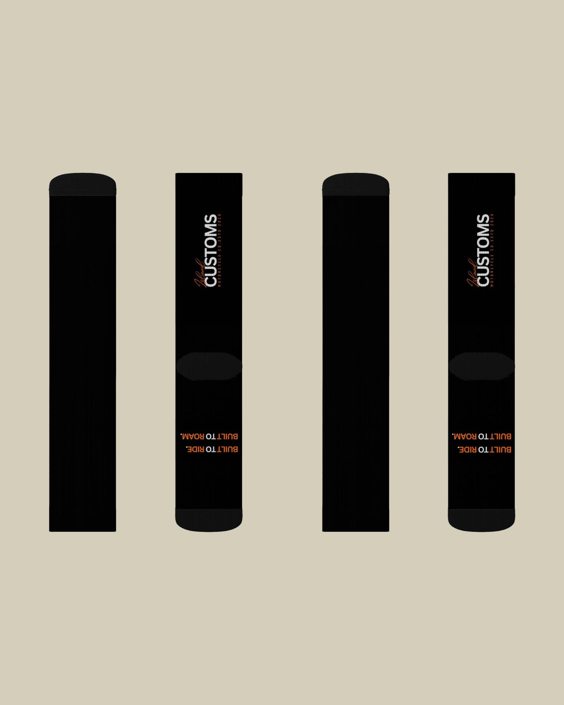 Four black cylindrical objects with 'CUSTOMS' branding on a beige background