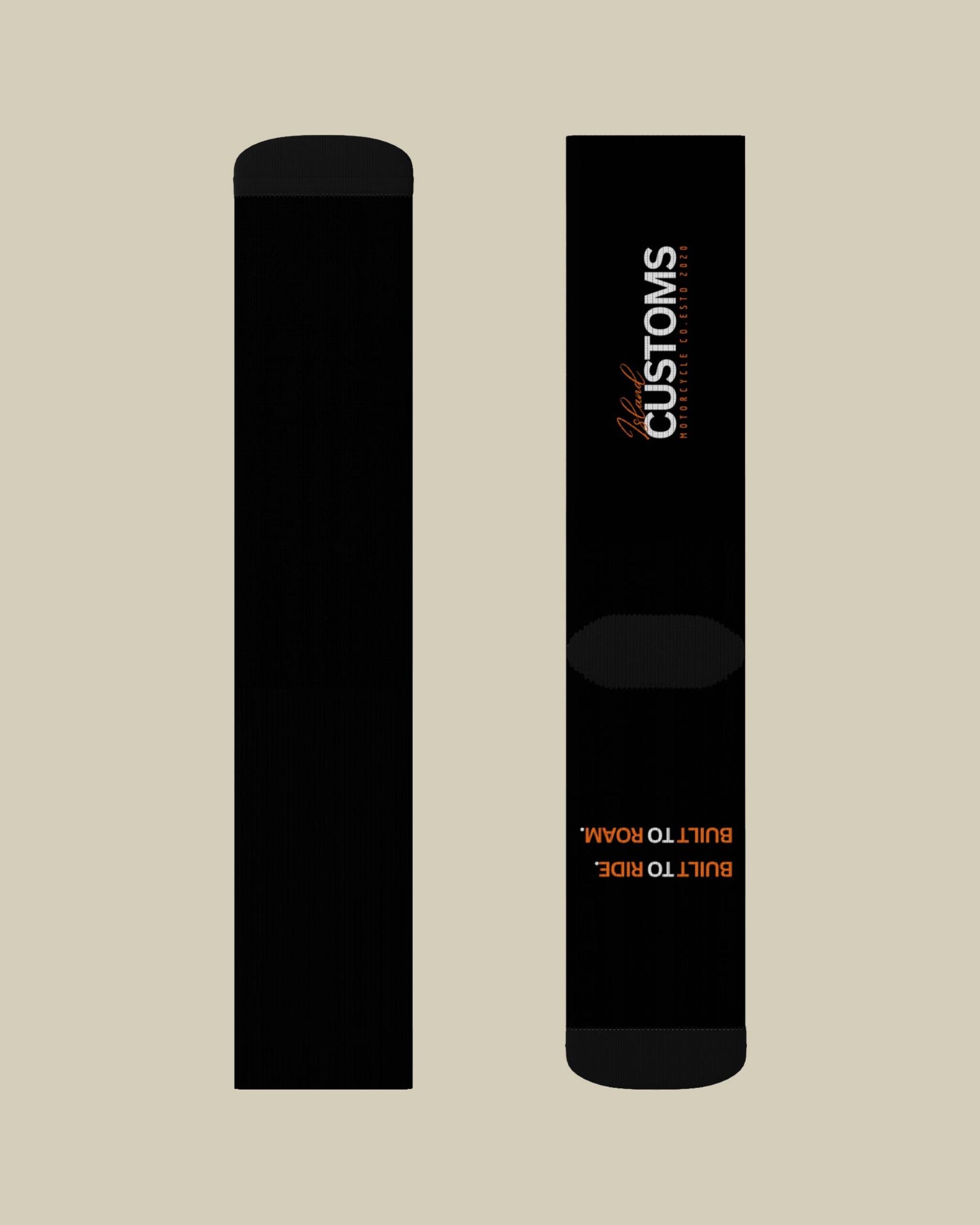 Two black cylindrical objects with 'CUSTOMS' branding on a beige background