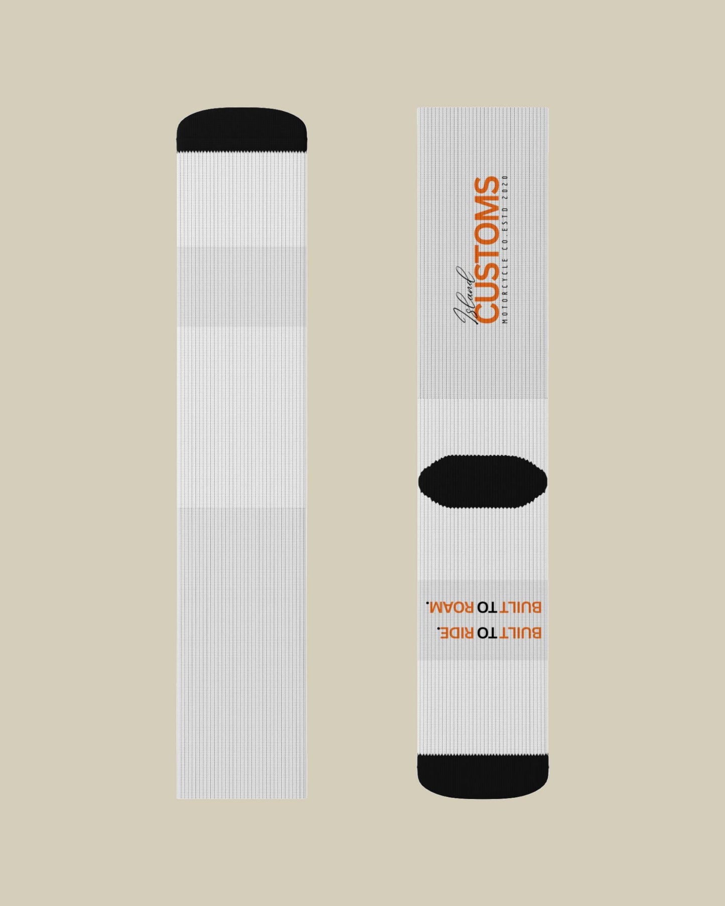 White socks with black accents and branding on a beige background