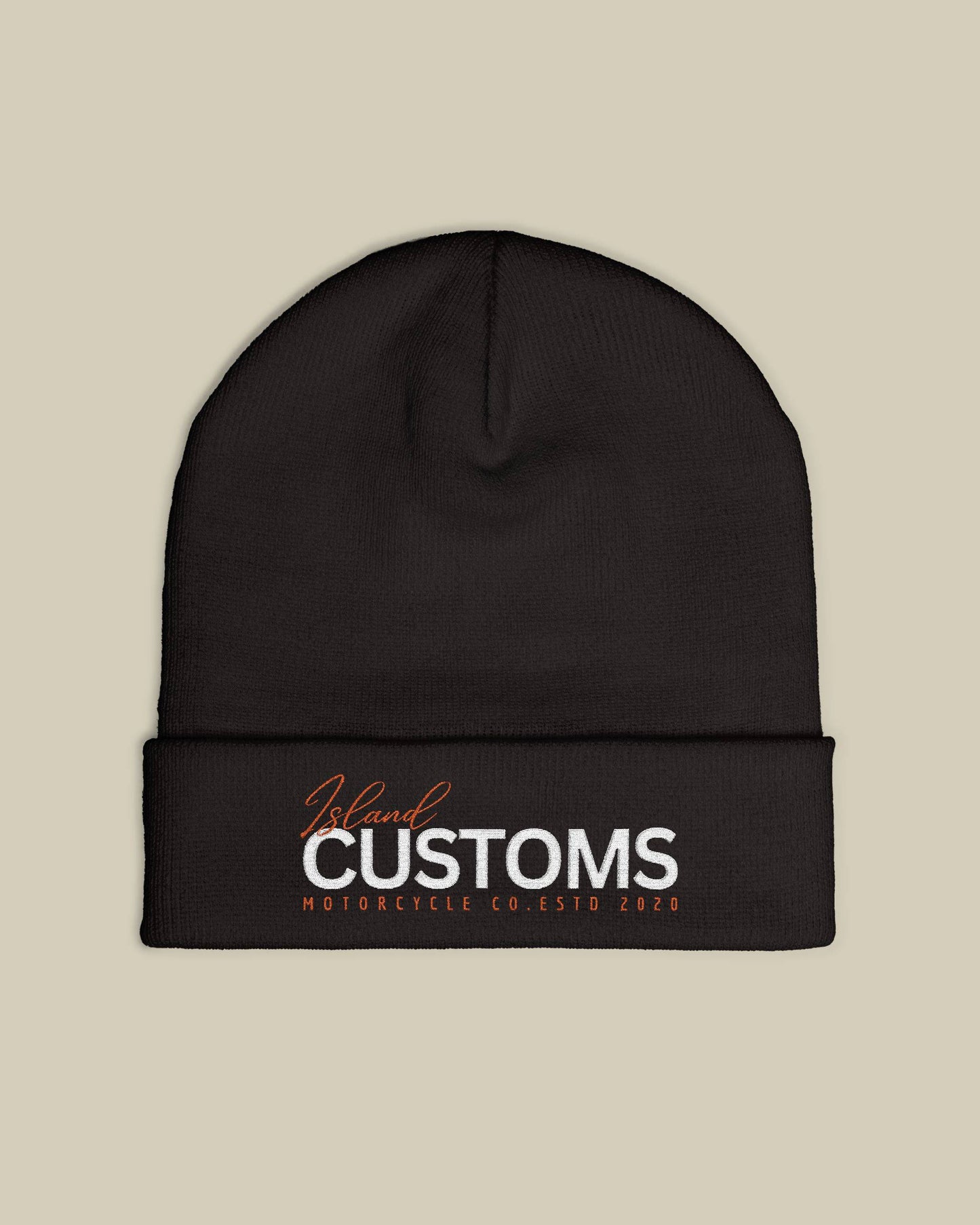 Black beanie with 'Customs' logo on a beige background