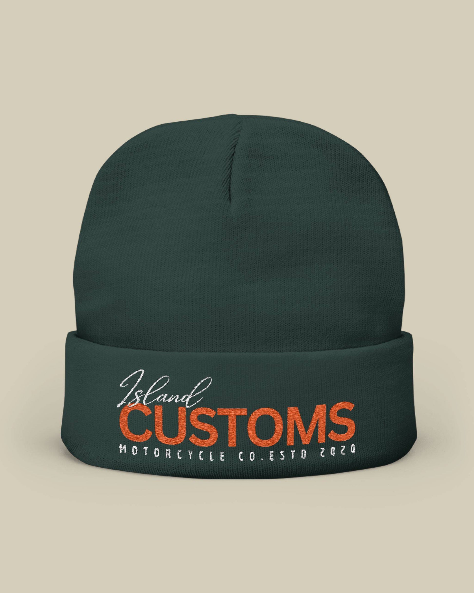 Dark green beanie with 'Island Customs Motorcycle Co.' text on a beige background