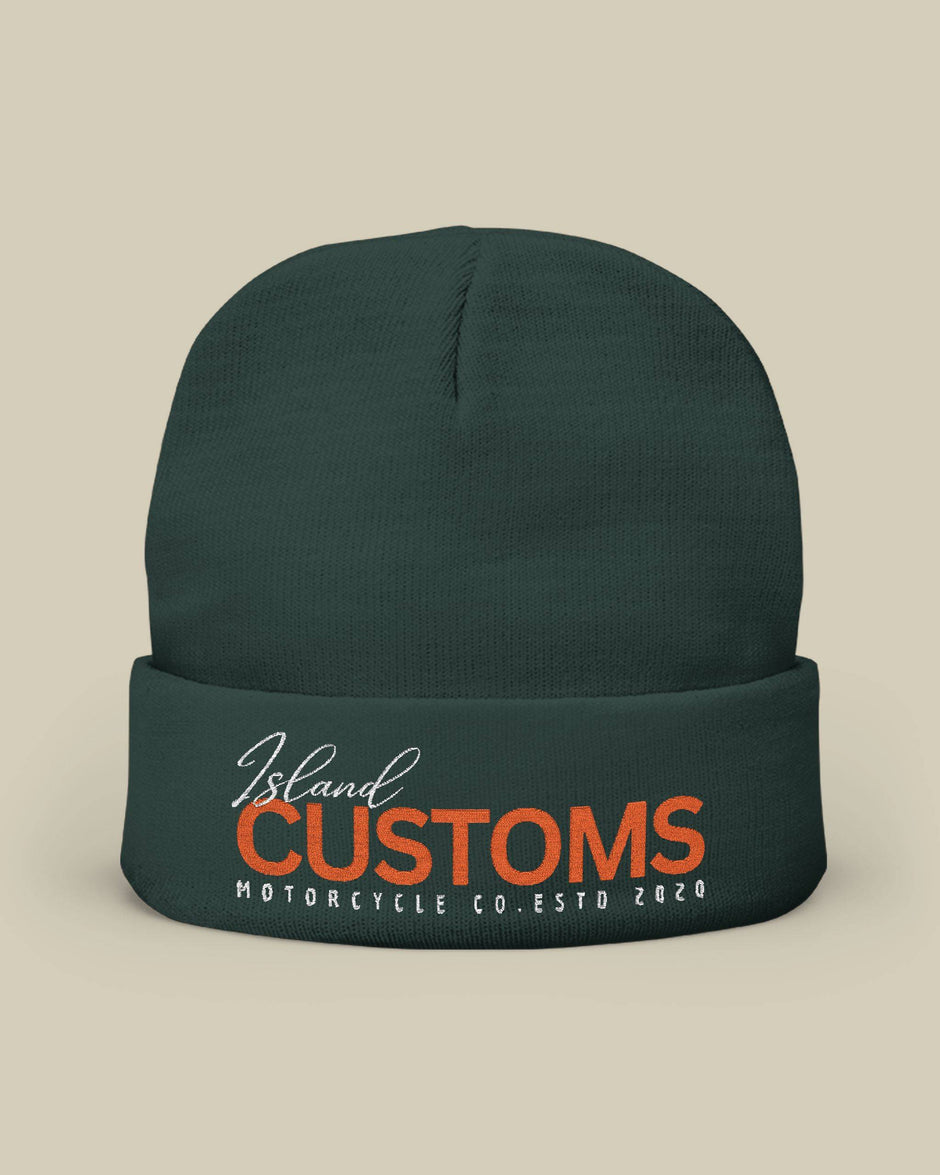 Dark green beanie with 'Island Customs Motorcycle Co.' text on a beige background