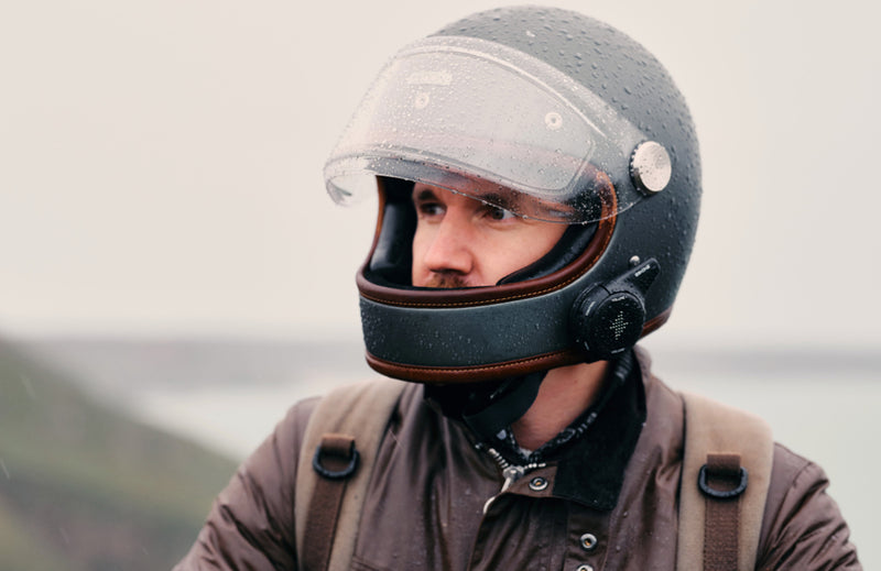 Person wearing a full-face helmet with a scenic background