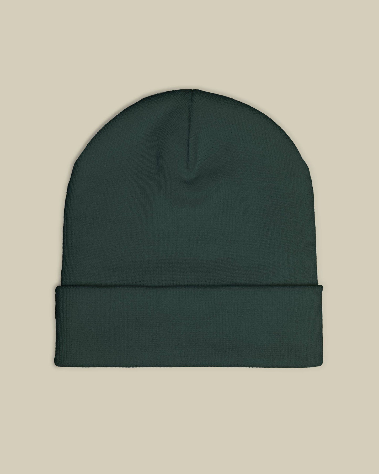 Dark green beanie on a beige background