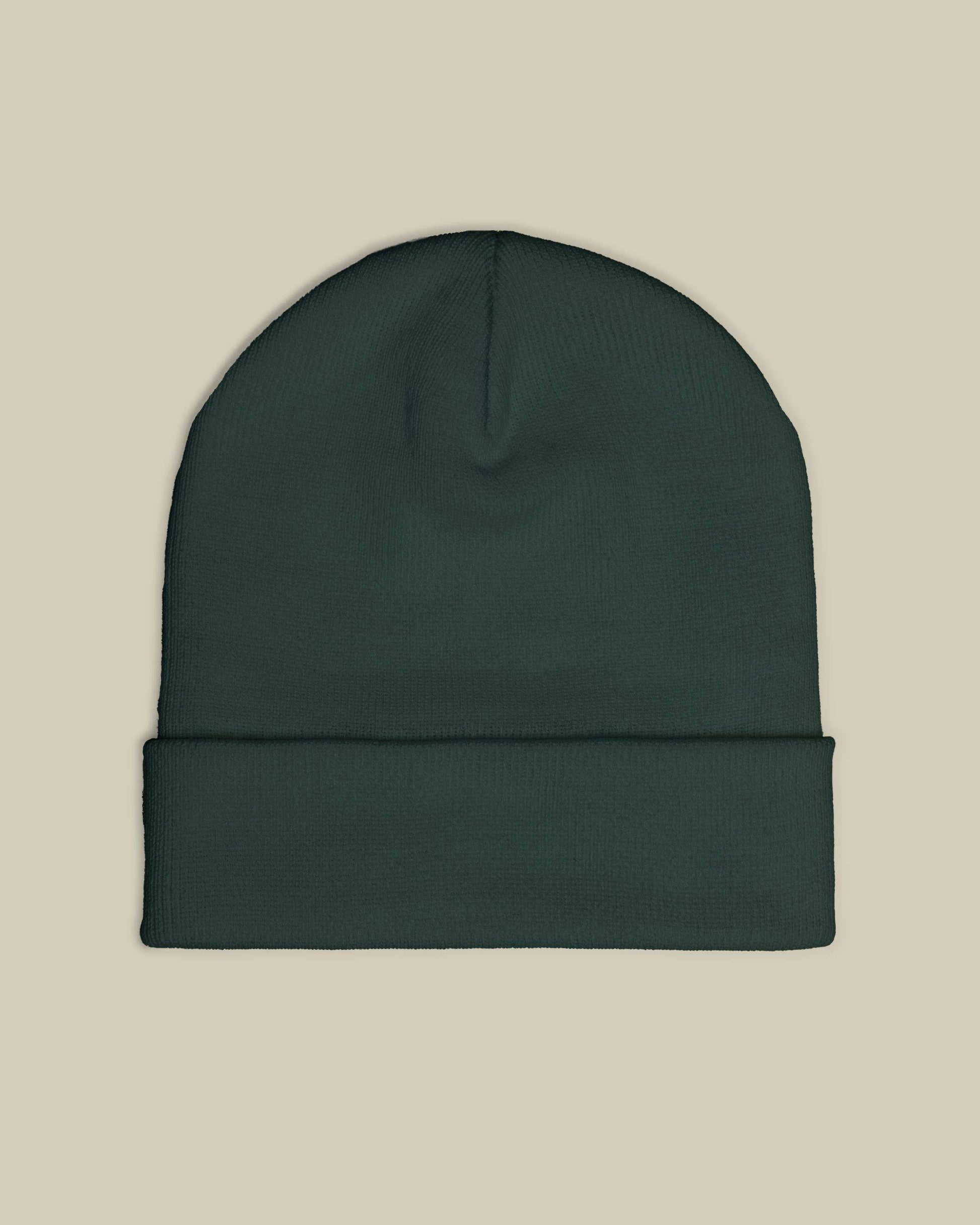 Dark green beanie on a beige background