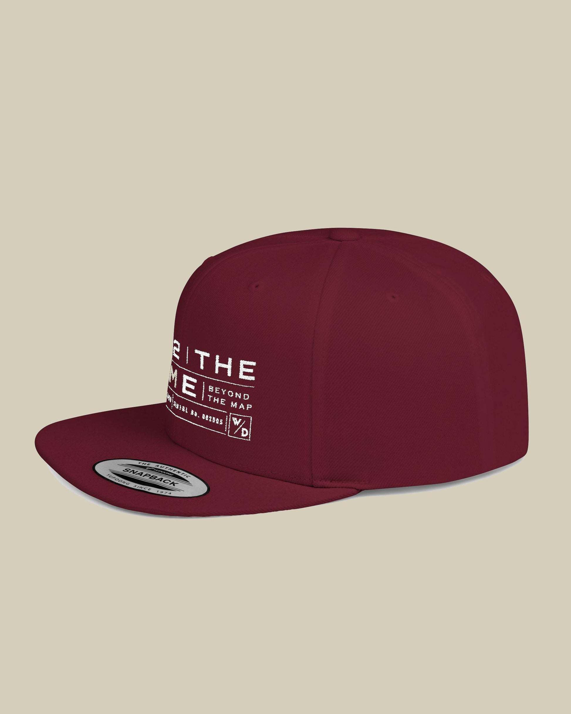 Maroon cap with white text on a beige background