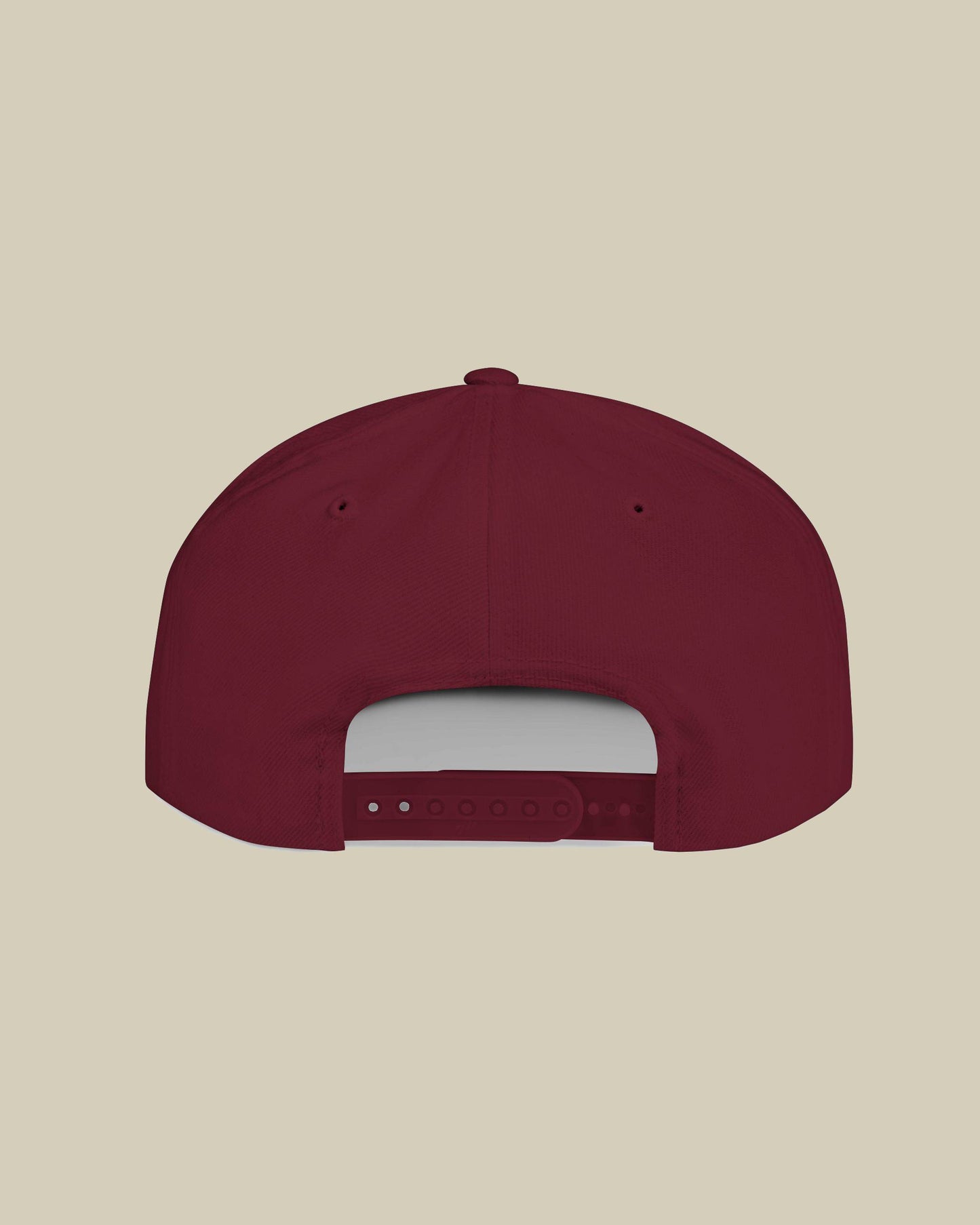 Maroon baseball cap on a beige background