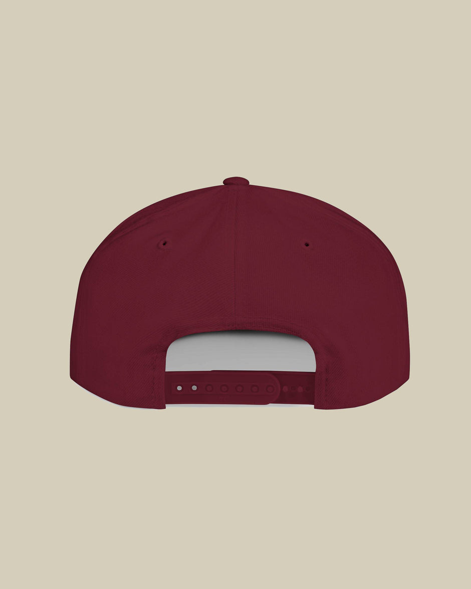 Maroon baseball cap on a beige background
