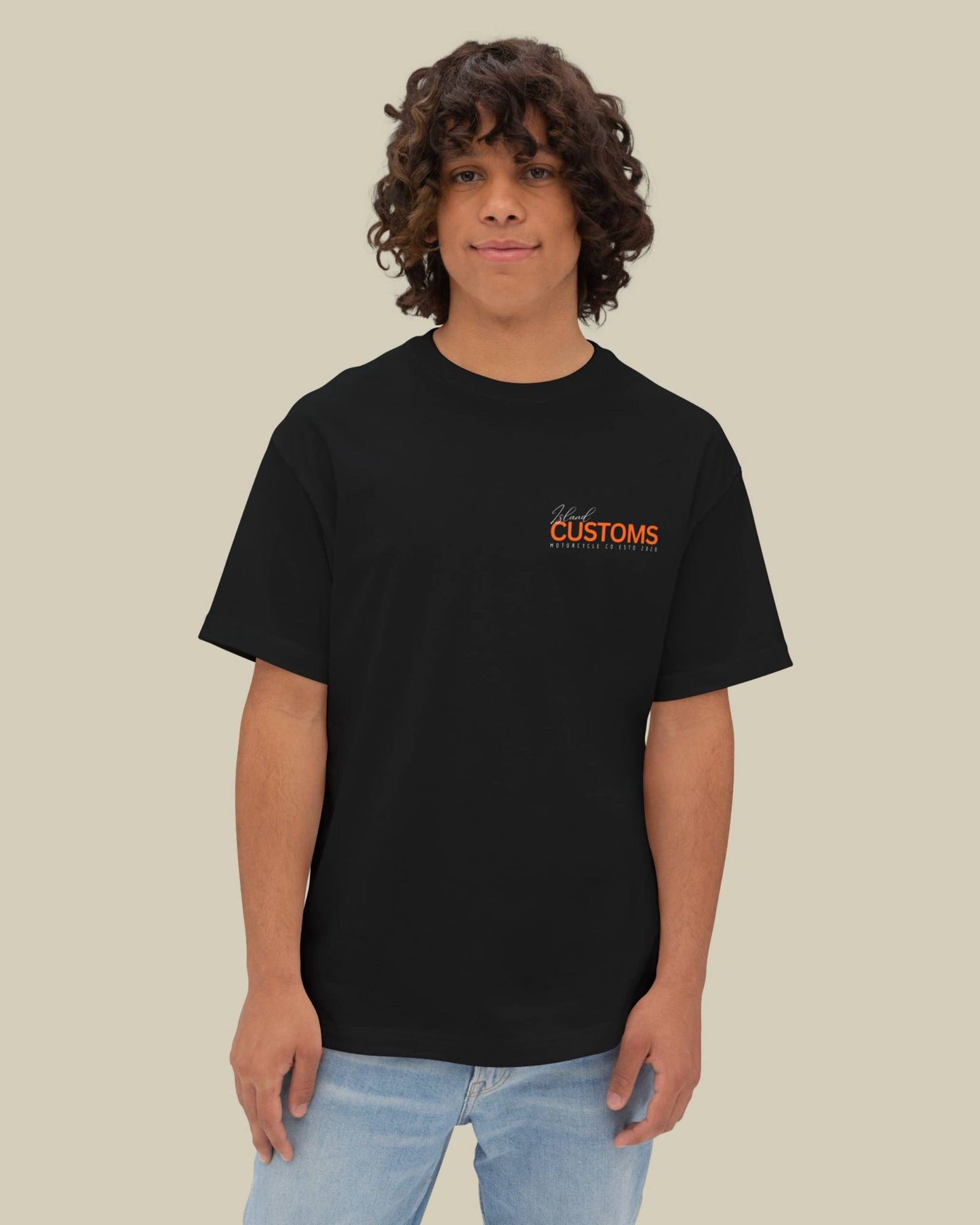 Person wearing a black t-shirt with orange text on a beige background