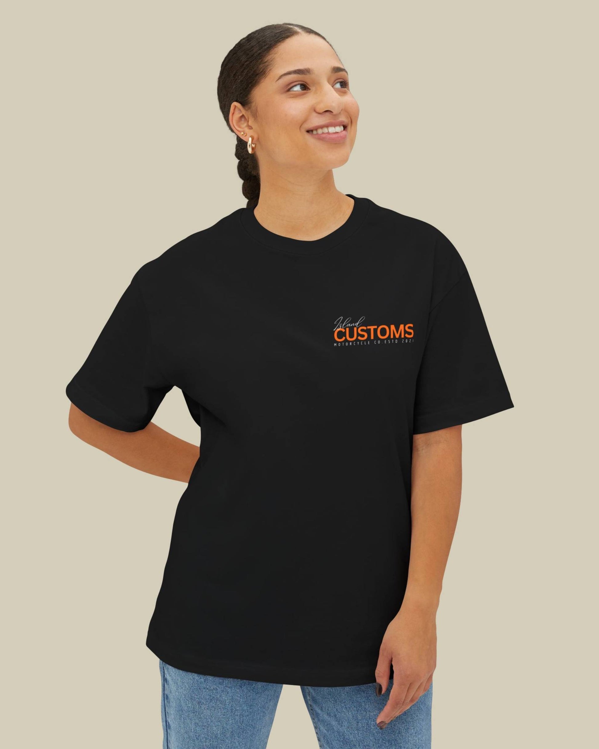 Person wearing a black t-shirt with 'Customs' text on a beige background
