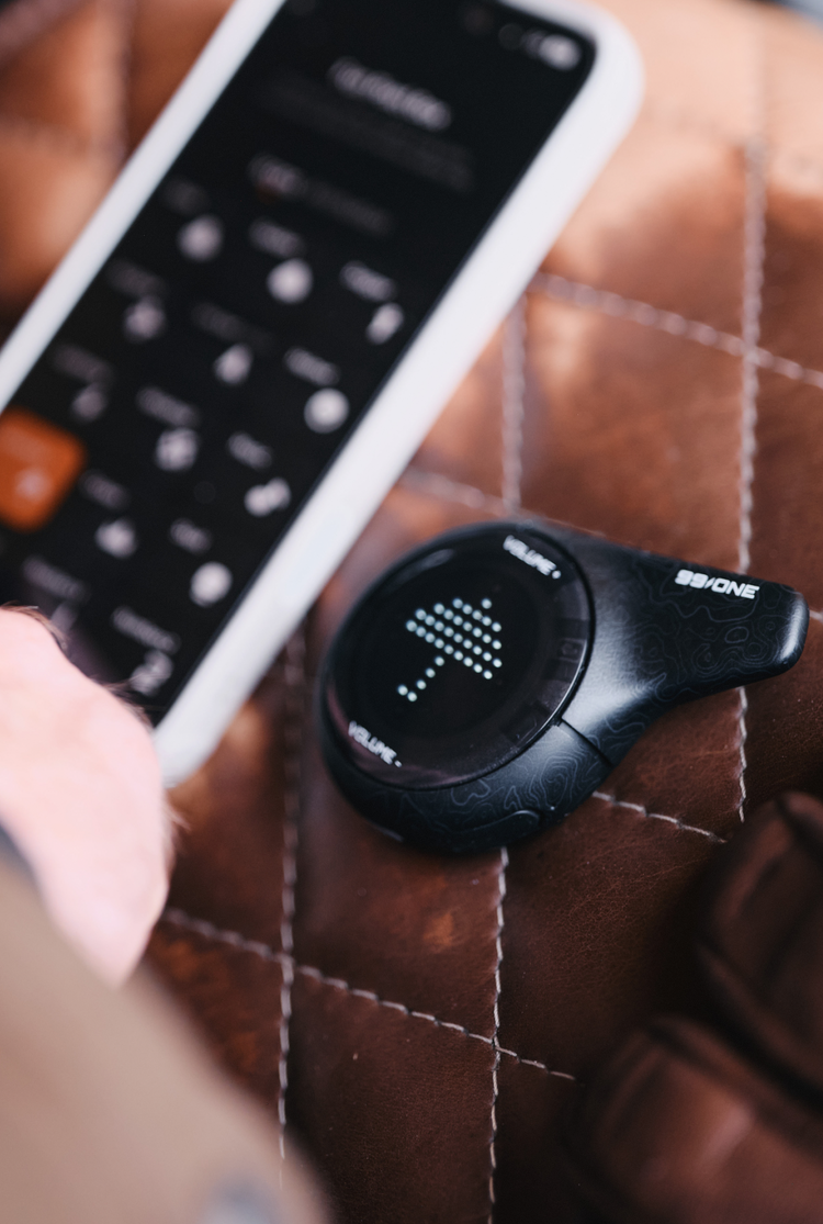 Black electronic device with digital display on a brown textured surface