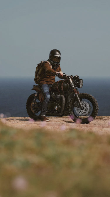 Person on a motorcycle overlooking a scenic landscape