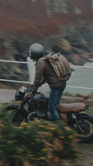 Person on a motorcycle with a scenic background